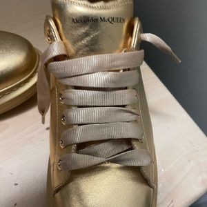 All gold Alexander McQueen sneakers.